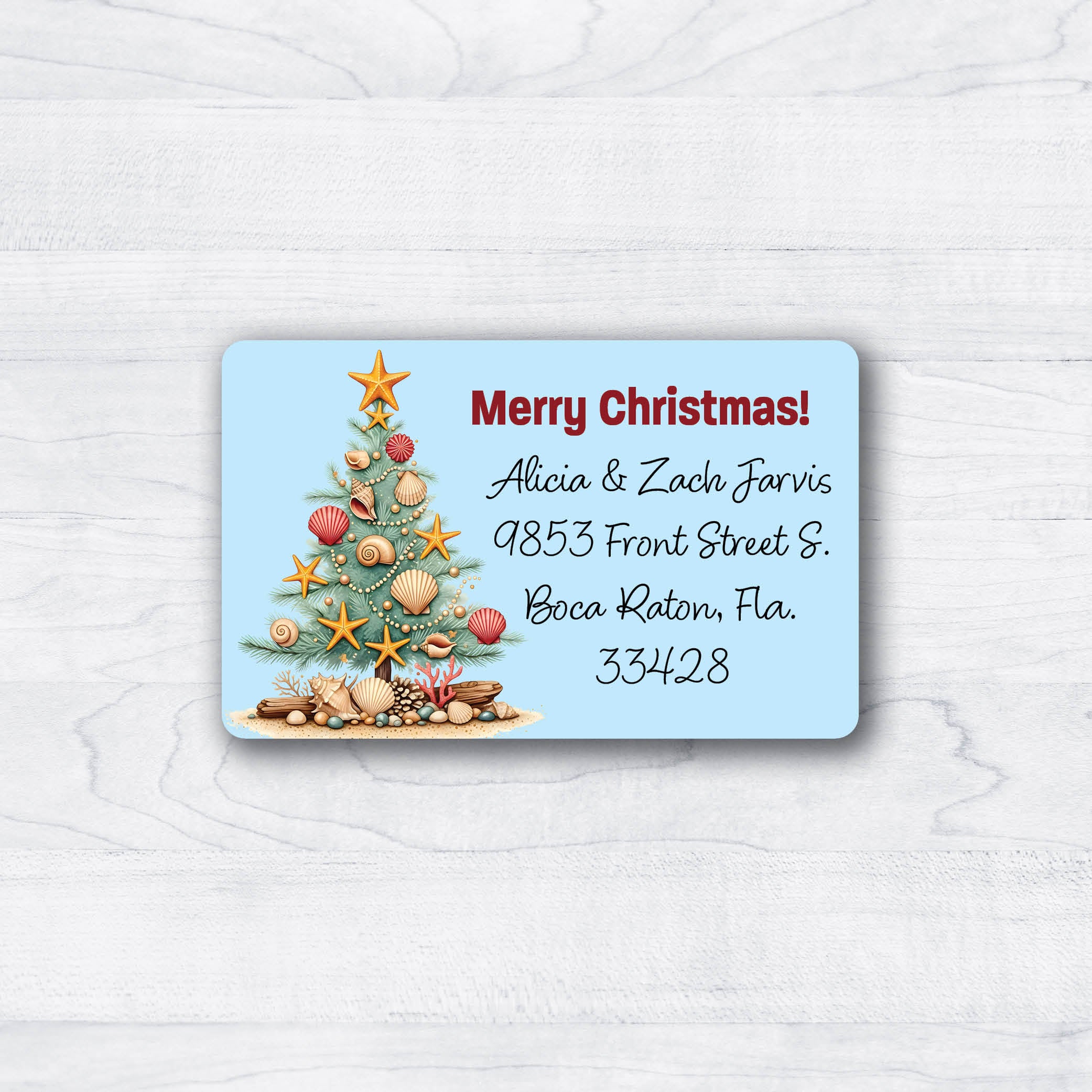 Christmas tree adorned with seashells on blue background return address labels for christmas