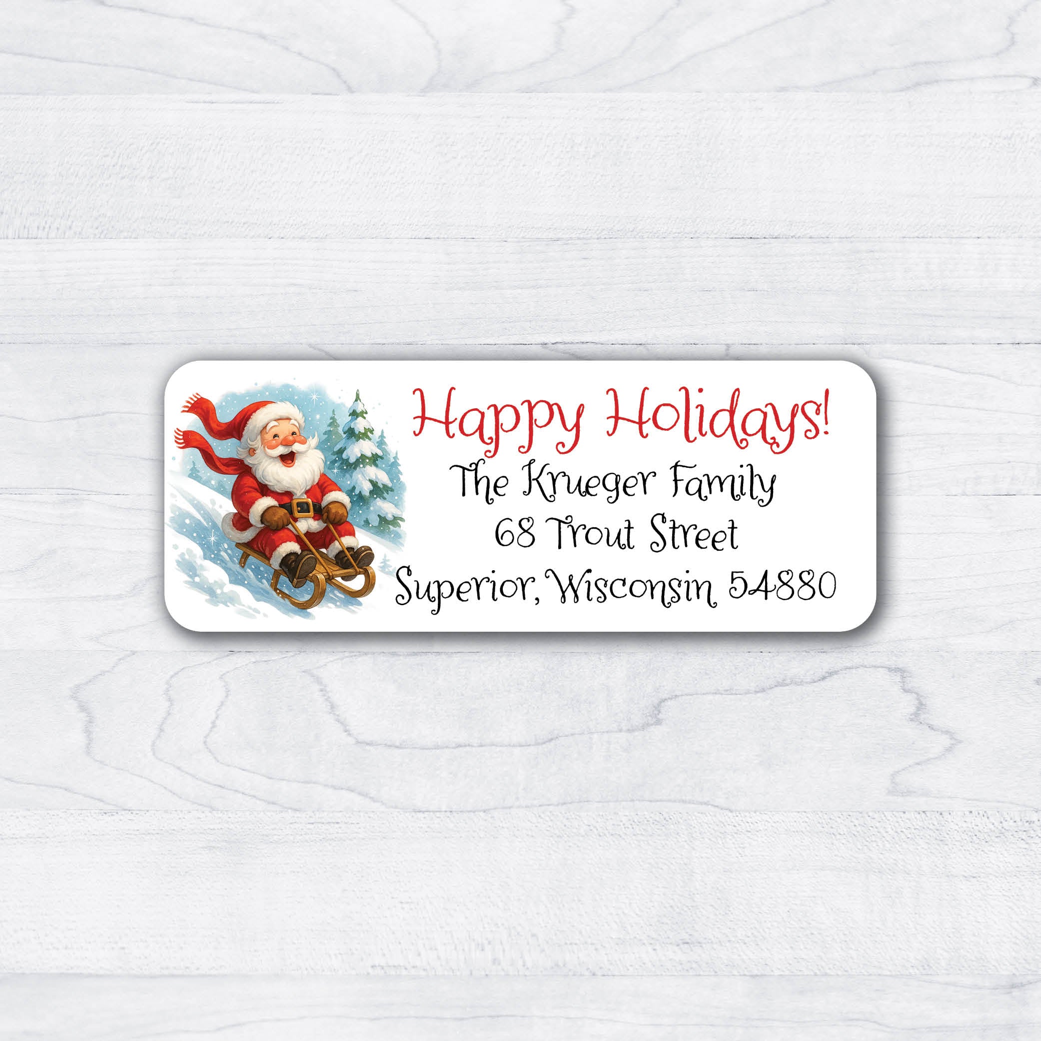 Christmas return address labels featuring Santa sledding downhill with a holiday message