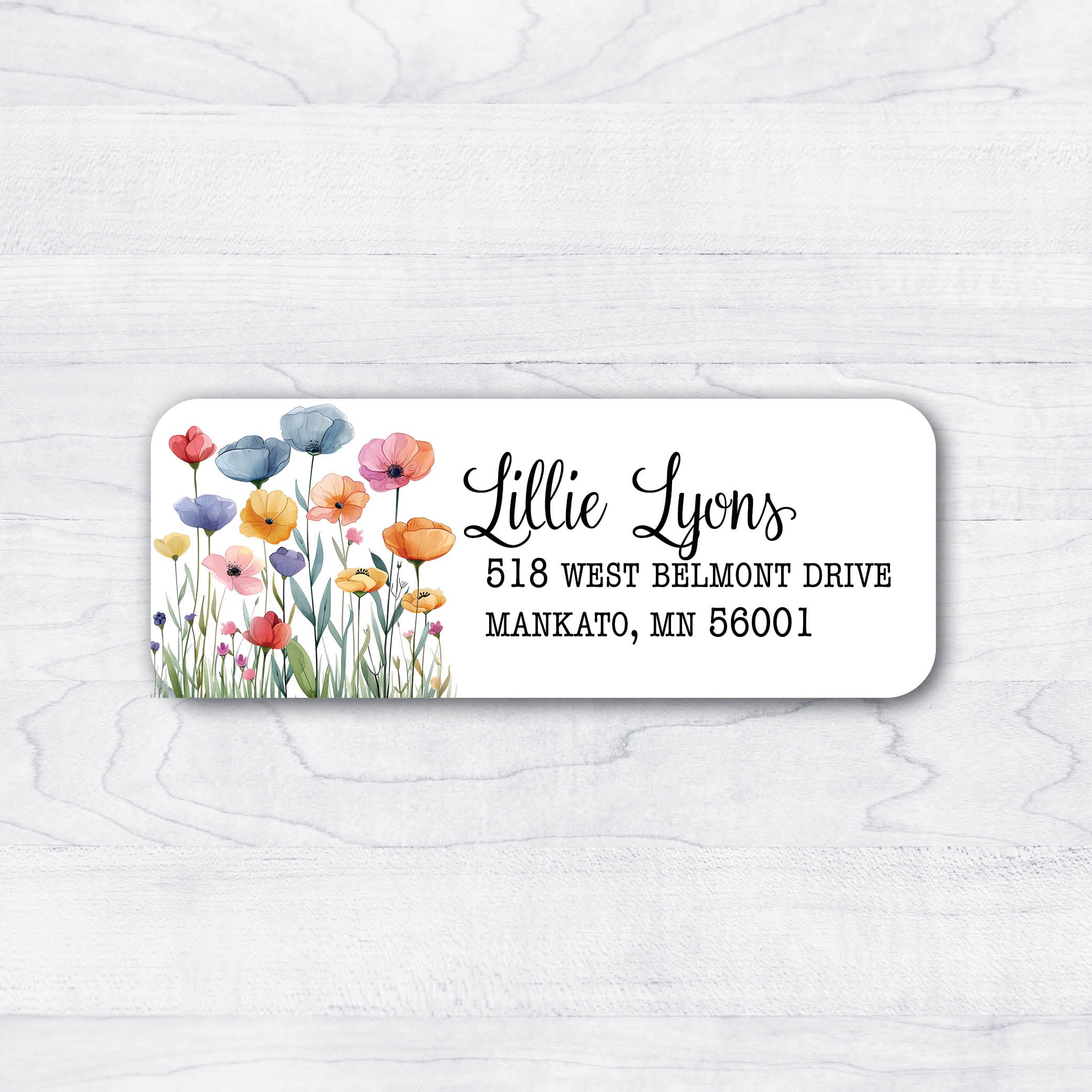 Red blue purple orange yellow pink flowers with green stems and script return address label