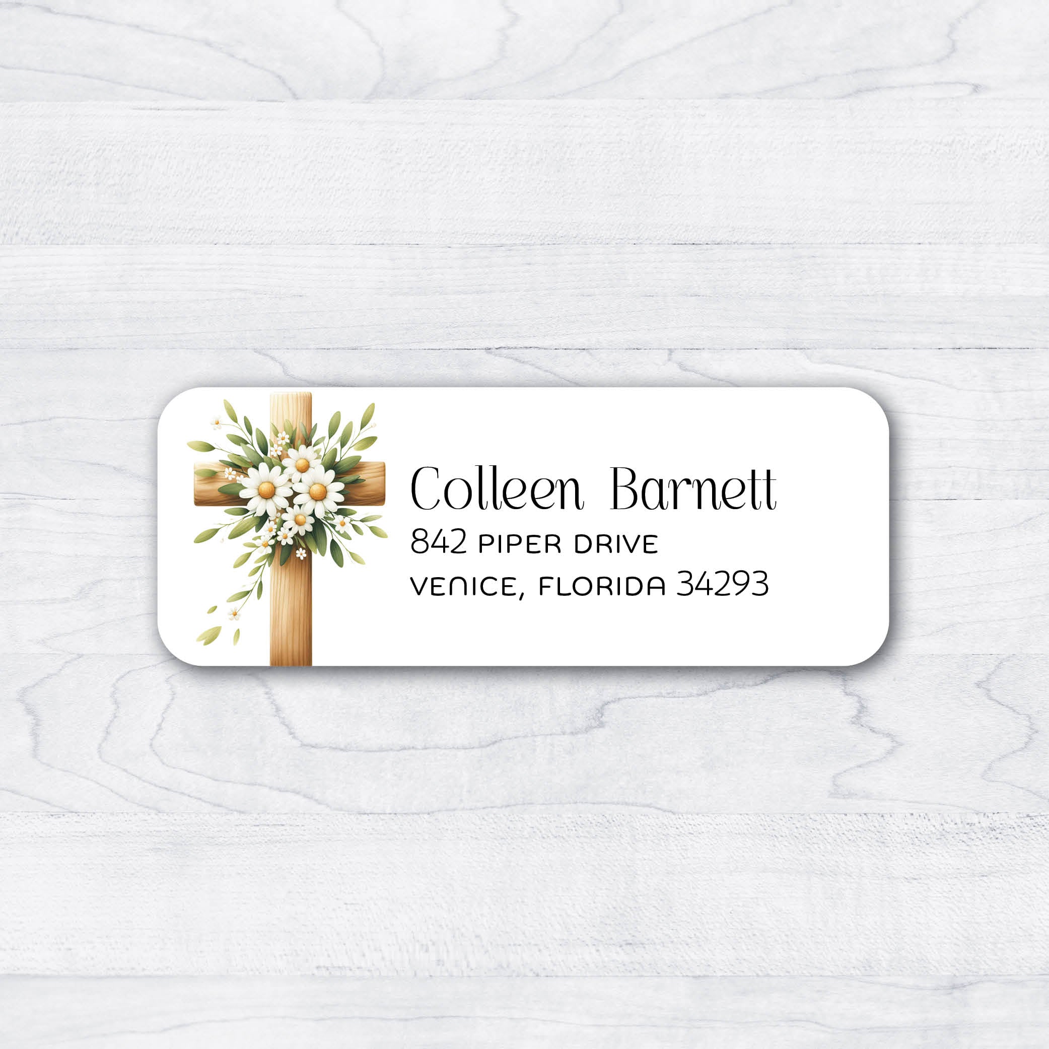 Christian themed Jesus themed cross return address labels with white flowers and green leaves.