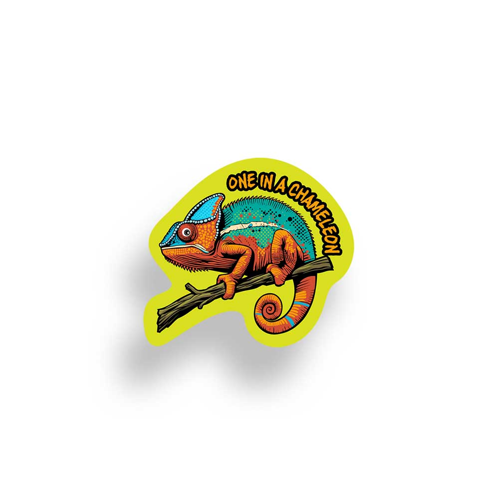 A die-cut sticker featuring a colorful chameleon perched on a branch, with the text 'ONE IN A CHAMELEON' in yellow around the top curve, shown on a white background with a soft drop shadow.