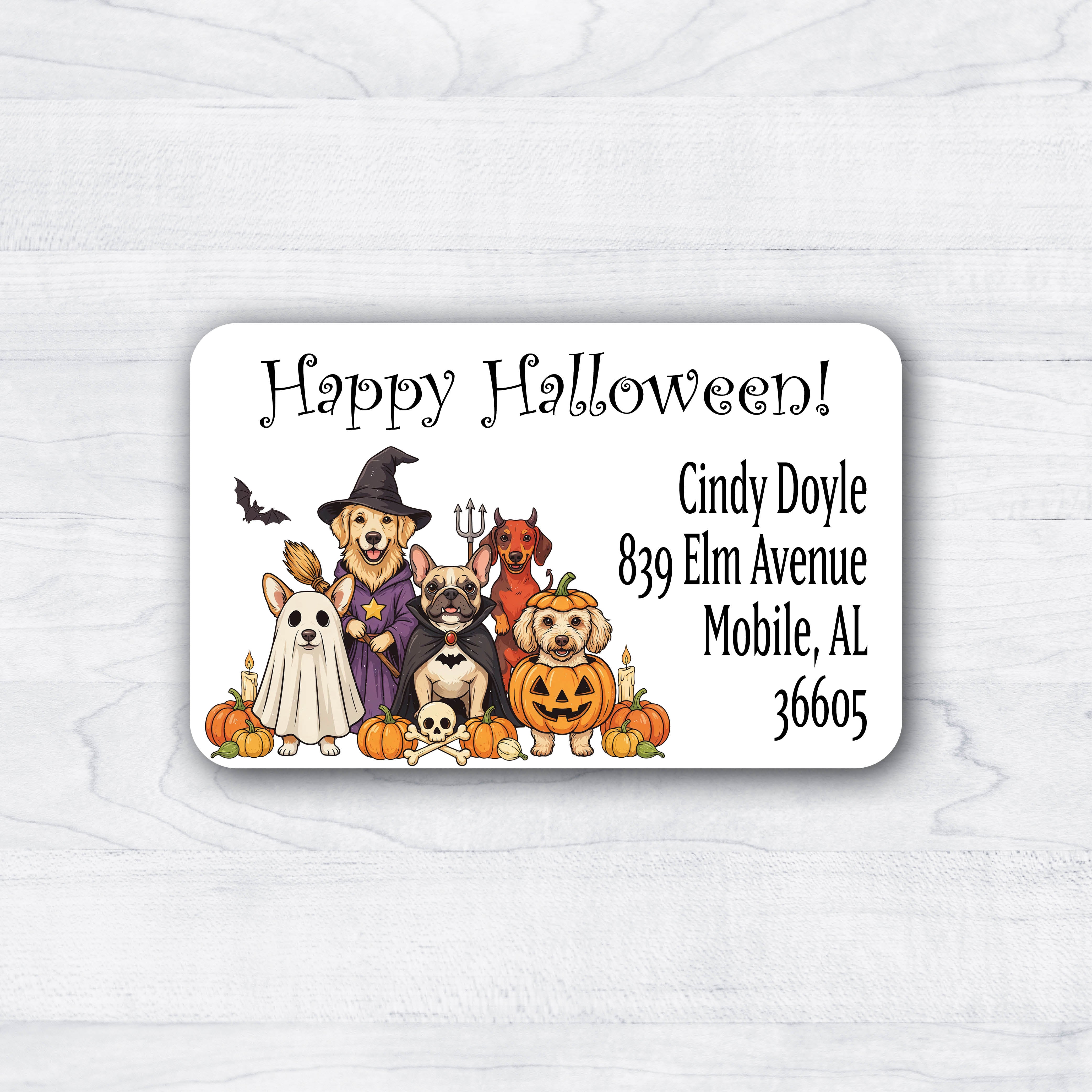 A rectangular Halloween address label with rounded corners, featuring a group of dogs dressed in costumes and pumpkins, plus the text 'Happy Halloween! 