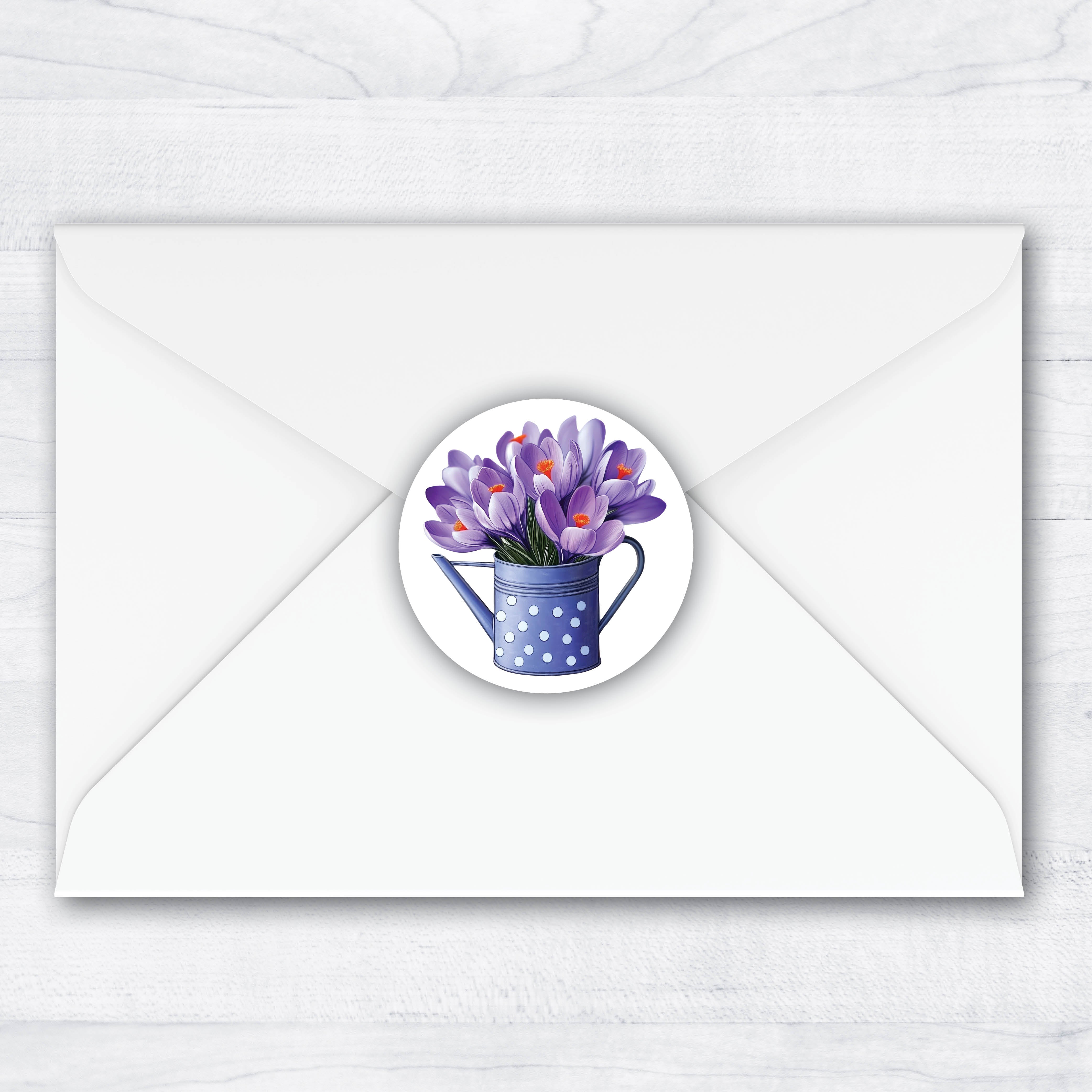 1.5 inch envelope seal with purple crocus bouquet inside a polka dot watering can.